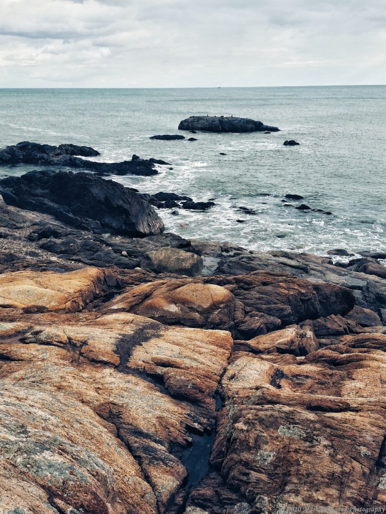 Image of a gloomy rocky shoreline scene.